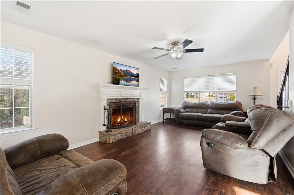 7140 Hunters Trace Drive Cumming, GA 30028 - Photo 11 of 35 a living room with furniture a window and a fireplace
