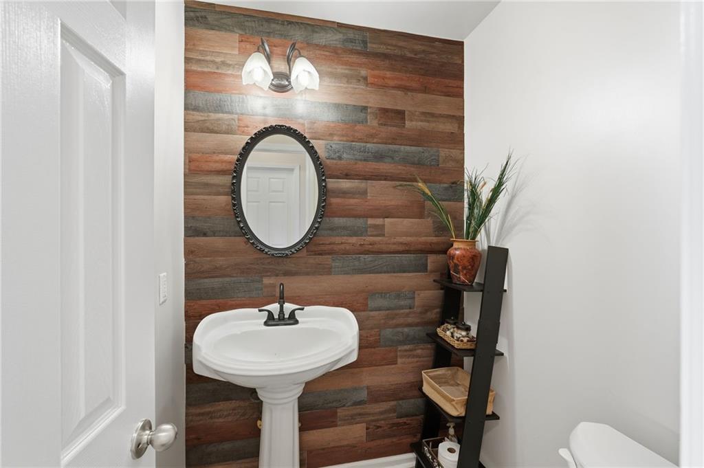 7140 Hunters Trace Drive Cumming, GA 30028 - Photo 18 of 35 a bathroom with a sink and a mirror