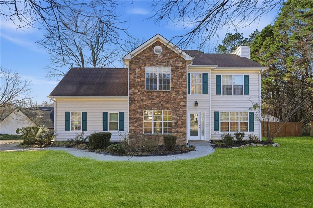 7140 Hunters Trace Drive Cumming, GA 30028 - Photo 2 of 35 a front view of house with yard and green space