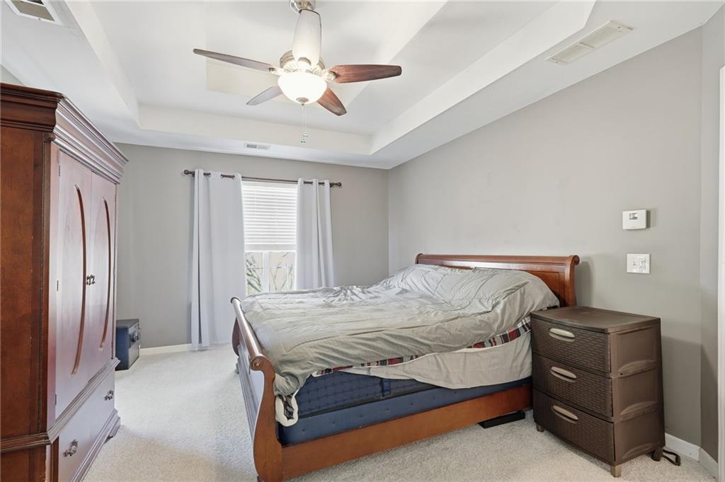 7140 Hunters Trace Drive Cumming, GA 30028 - Photo 21 of 35 a bedroom with a bed and a chandelier