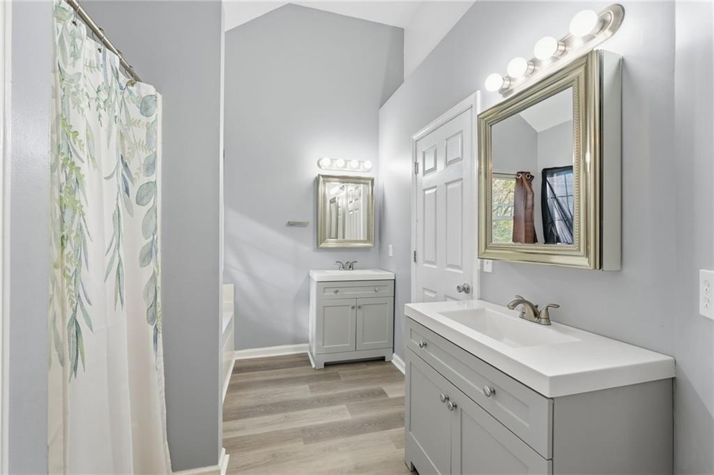 7140 Hunters Trace Drive Cumming, GA 30028 - Photo 22 of 35 a bathroom with a double vanity sink mirror and