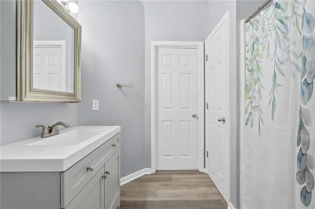 7140 Hunters Trace Drive Cumming, GA 30028 - Photo 24 of 35 a bathroom with a sink and a mirror
