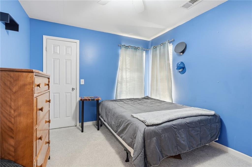7140 Hunters Trace Drive Cumming, GA 30028 - Photo 25 of 35 a bedroom with a bed and a refrigerator