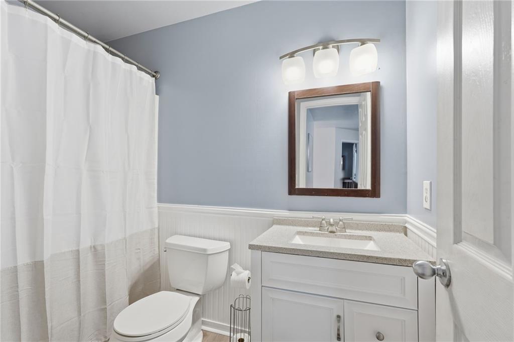 7140 Hunters Trace Drive Cumming, GA 30028 - Photo 28 of 35 a bathroom with a toilet sink and mirror