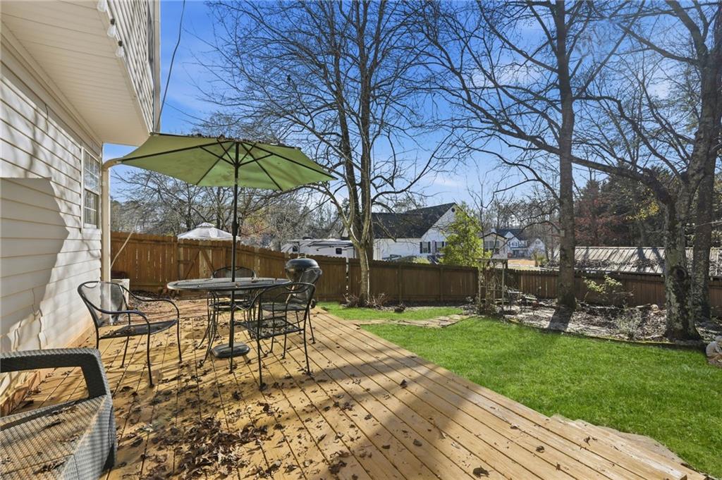 7140 Hunters Trace Drive Cumming, GA 30028 - Photo 30 of 35 a view of a table and chairs under an umbrella