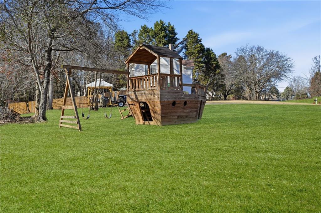 7140 Hunters Trace Drive Cumming, GA 30028 - Photo 34 of 35 a view of a park with a large tree
