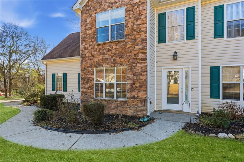 7140 Hunters Trace Drive Cumming, GA 30028 - Photo 5 of 35 a front view of a house with garden