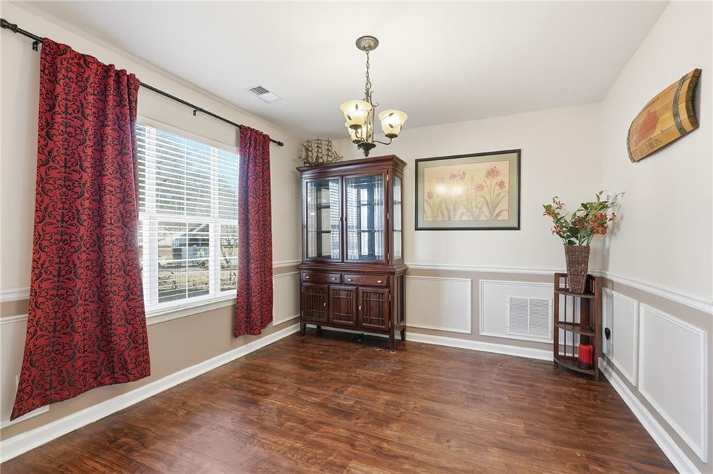 7140 Hunters Trace Drive Cumming, GA 30028 - Photo 8 of 35 a view of livingroom with furniture wooden floor and windows