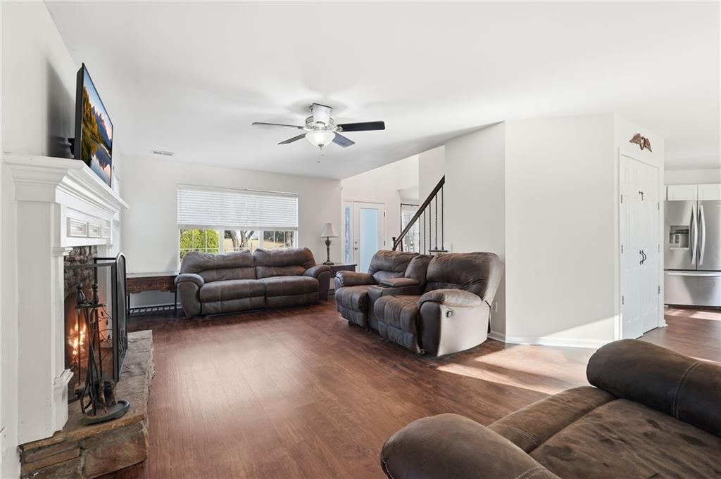 7140 Hunters Trace Drive Cumming, GA 30028 - Photo 10 of 35 a living room with furniture ceiling fan and a rug