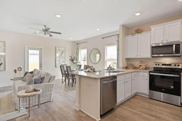 a large kitchen with stainless steel appliances granite countertop a stove a sink and a refrigerator