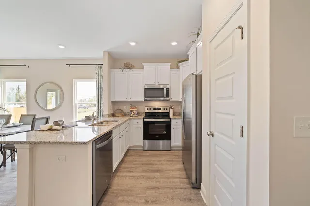a living room with kitchen island furniture and a kitchen view
