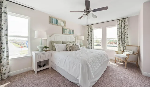 a bedroom with a bed a mirror and a lamp on a dresser