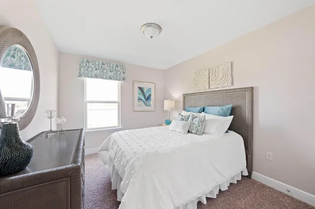 a bedroom with bunk bed and a window