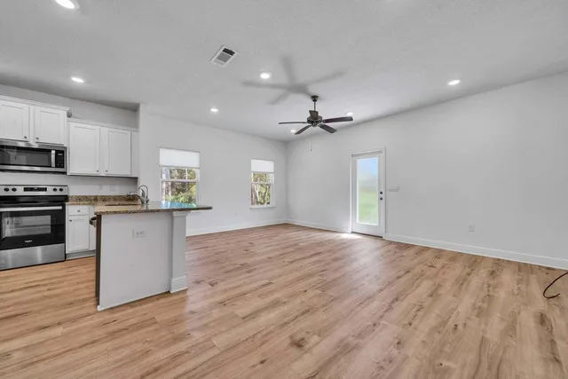 a view of kitchen with sink and wooden floor