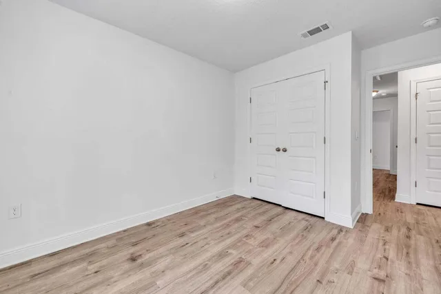 a view of room with wooden floor