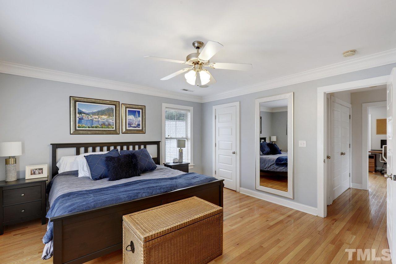 121 East Seeman Street Durham, NC 27701 - Photo 16 of 31 a bedroom with a bed and a chandelier