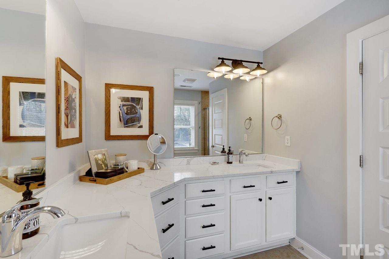 121 East Seeman Street Durham, NC 27701 - Photo 18 of 31 a bathroom with a double vanity sink and a mirror