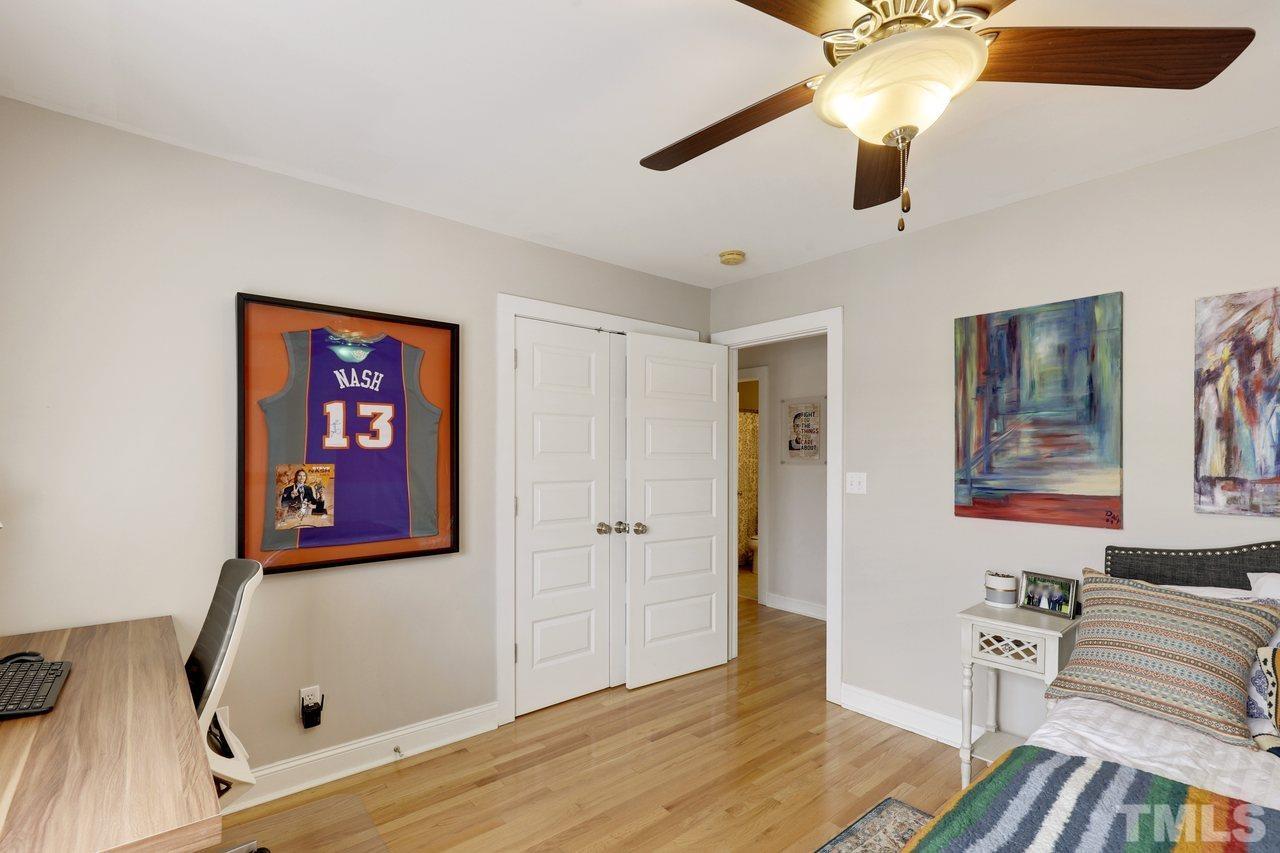 121 East Seeman Street Durham, NC 27701 - Photo 20 of 31 a bedroom with furniture and a chandelier