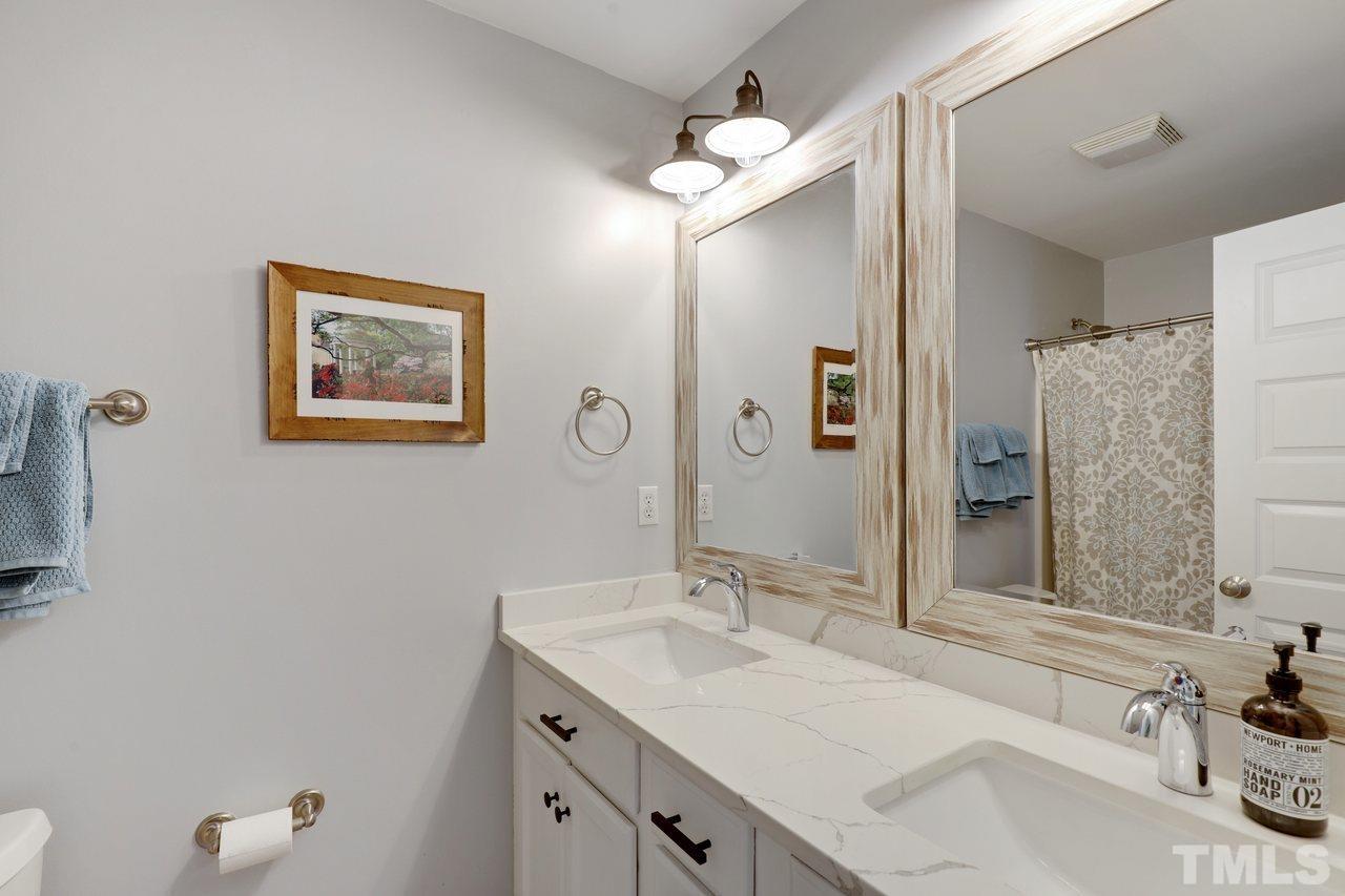 121 East Seeman Street Durham, NC 27701 - Photo 23 of 31 a bathroom with a tub sink and mirror