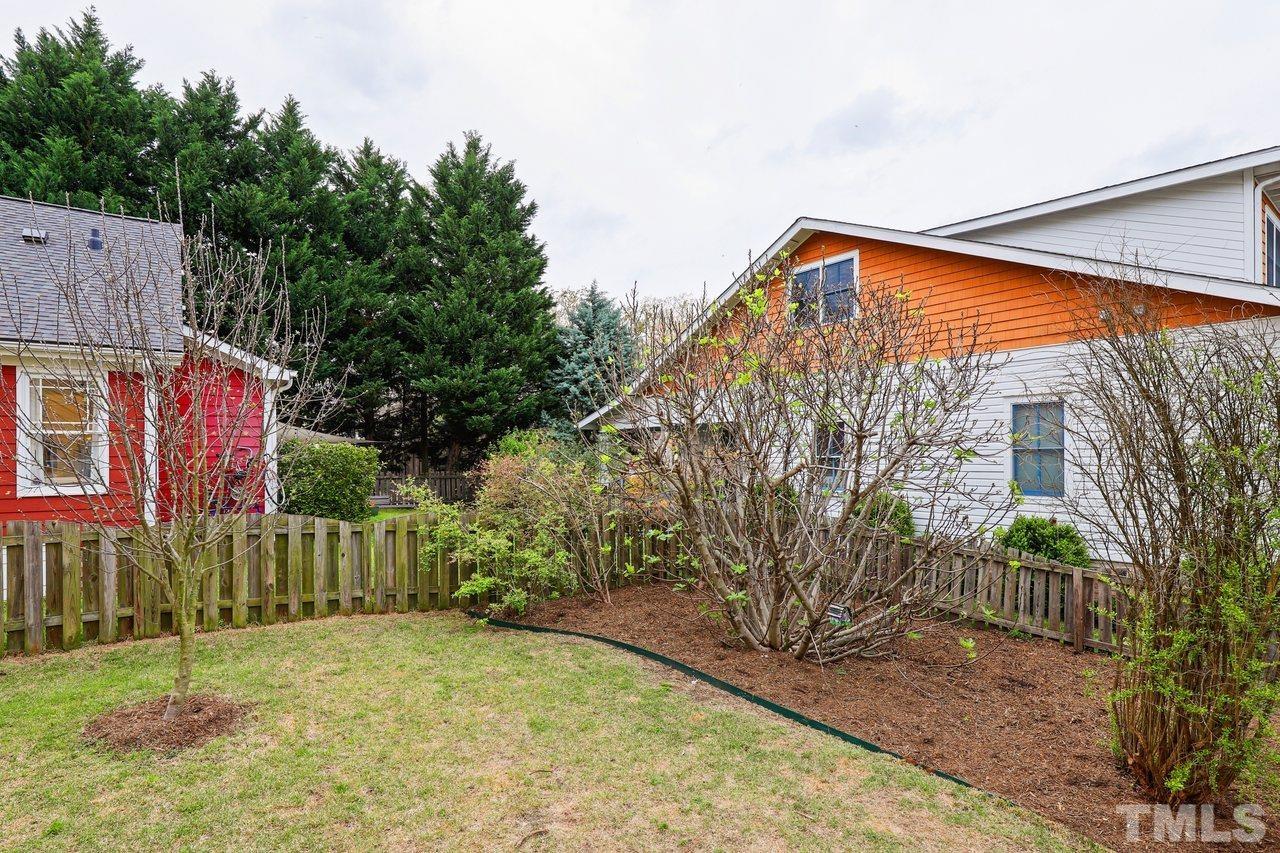 121 East Seeman Street Durham, NC 27701 - Photo 26 of 31 a view of backyard with small cabin and wooden fence