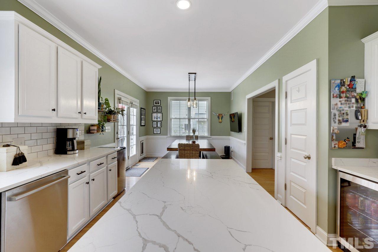 121 East Seeman Street Durham, NC 27701 - Photo 8 of 31 a large white kitchen with stainless steel appliances granite countertop a lot of counter space and a refrigerator