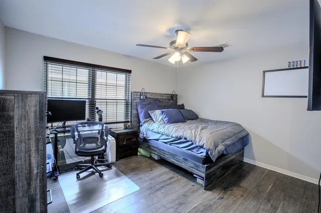a bedroom with a bed window and a flat screen tv