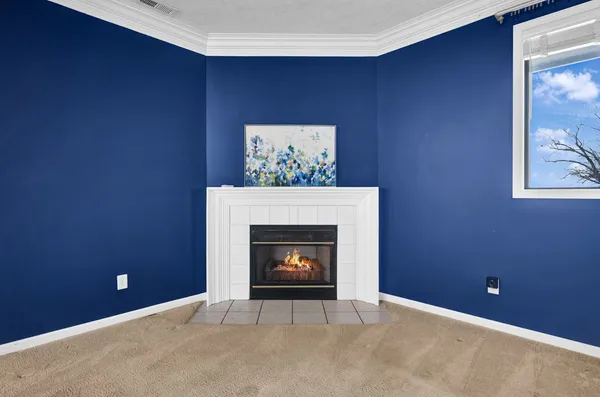 an empty room with window and ceiling fan