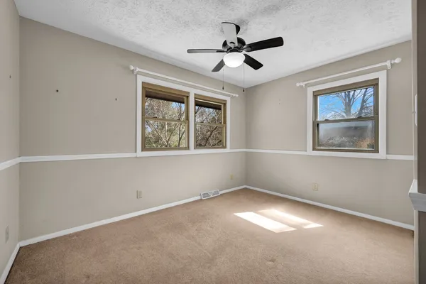 a view of a room with wooden floor table and chairs