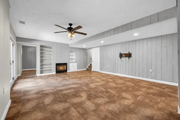 a view of a room with window and a ceiling fan