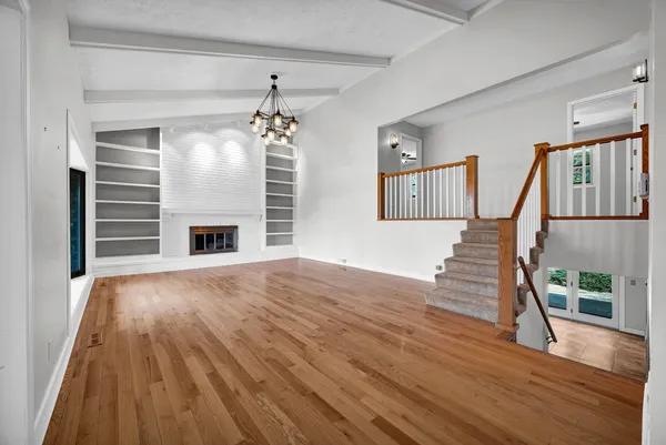 a living room with fireplace furniture and a wooden floor