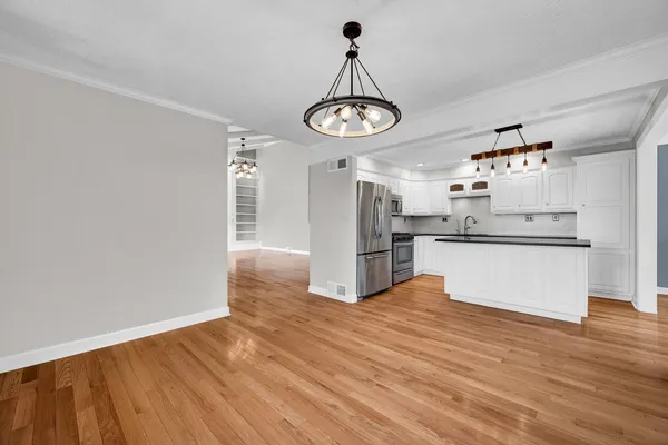 a kitchen with stainless steel appliances granite countertop a stove and a refrigerator