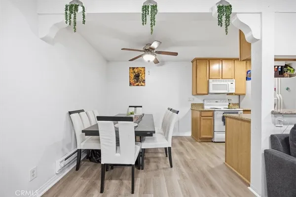 a view of a dining room with furniture and wooden floor