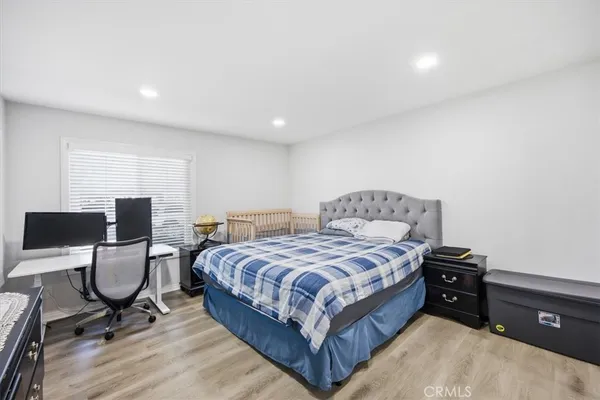 a bedroom with a bed and a furniture