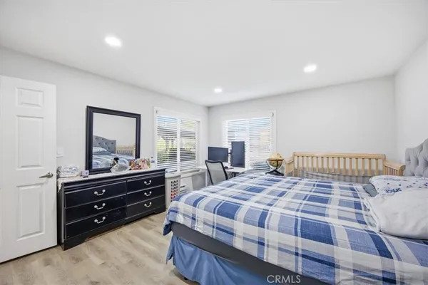 a bedroom with a bed and a dresser