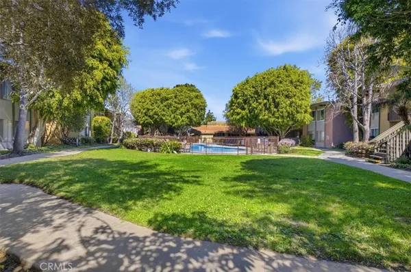 a view of a garden with a building in the background