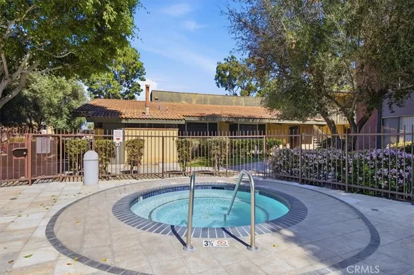 a view of a house with swimming pool and sitting area