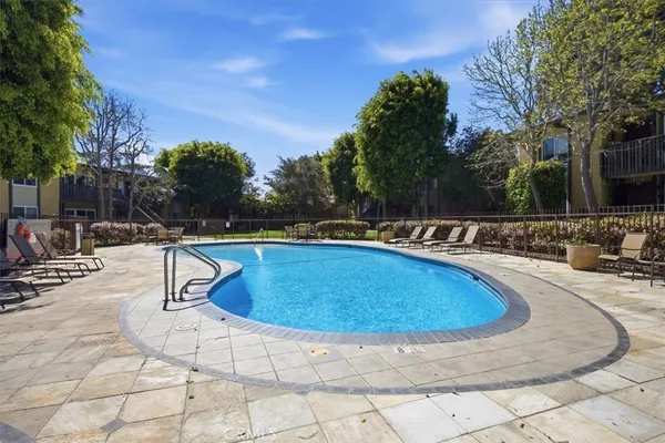 a swimming pool with outdoor seating and yard
