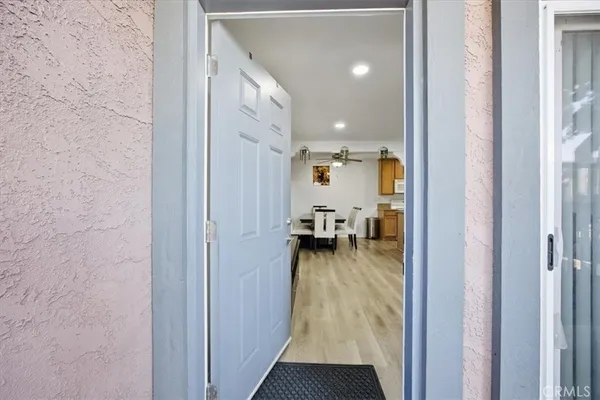 a view of a hallway with a view of living room and dining room