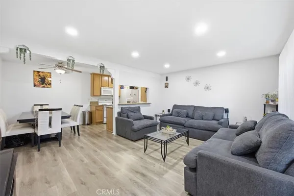 a living room with furniture and a wooden floor