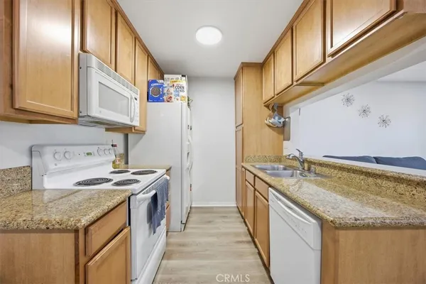 a kitchen with stainless steel appliances granite countertop a sink and a stove
