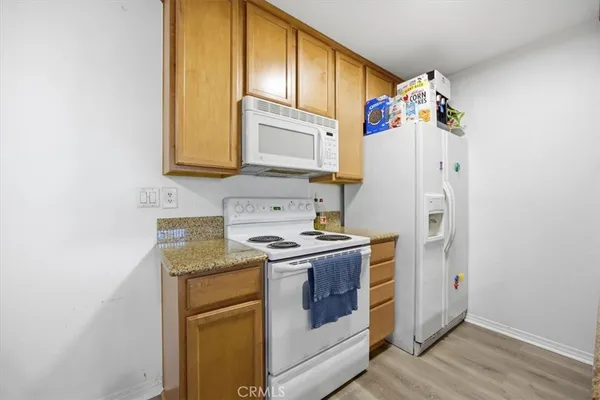 a kitchen with a stove a refrigerator and a sink