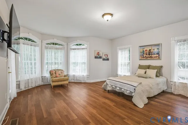 a bedroom with a bed and a couch