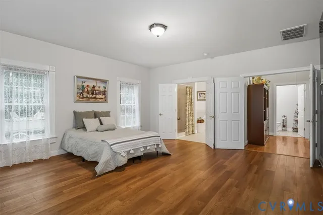 a spacious bedroom with a bed and a large window