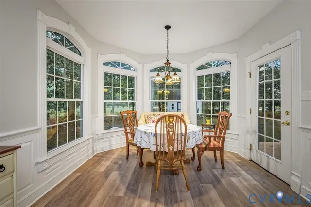 a view of a dining room with furniture window and wooden floor