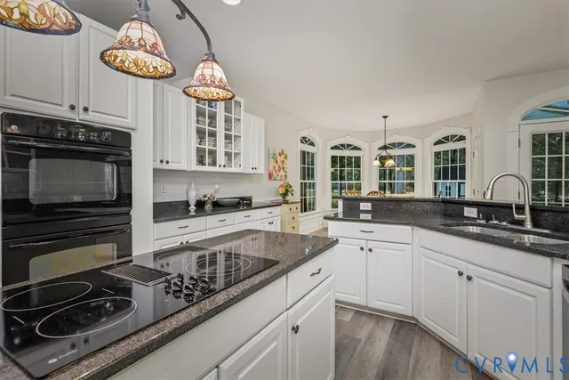 a kitchen with cabinets and stainless steel appliances