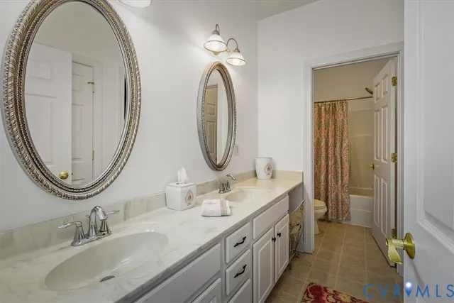 a spacious bathroom with a double vanity sink and a mirror