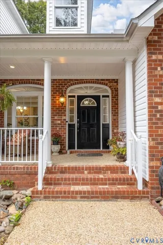 a view of a brick house with large windows