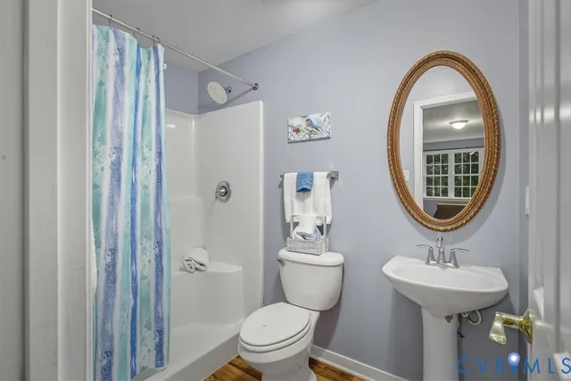 a bathroom with a toilet a sink and a mirror