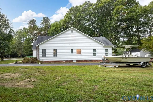 a view of a house with a yard and sitting area