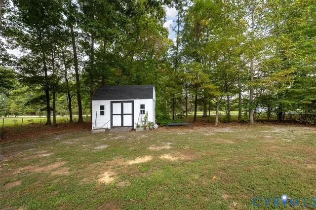 a view of a house with a yard and tree s